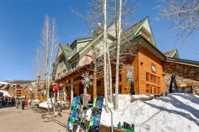a ski lodge with skis parked outside of it at River Run Village 1 Bedroom Condo in Keystone