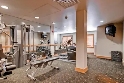 a gym with treadmills and machines in a room at River Run Village 1 Bedroom Condo in Keystone