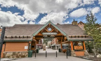 a large wooden building with a sign on it at River Run Village 2 Bedroom Condo - 100 Yards To Slopes, Pool, Hot Tub Access in Keystone