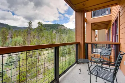 a balcony with a table and a chair on it at Springs 8860 in Keystone