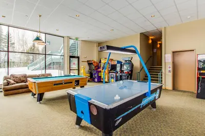 a living room with a pool table in it at Treehouse 202 in Silverthorne