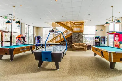 a gym with two pool tables and a slide at Treehouse 202 in Silverthorne
