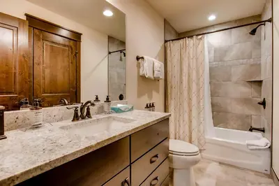 a bathroom with a sink and a toilet and a shower at River Run Townhome RR38 in Keystone