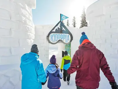 a group of people walking towards a sign in the snow at River Run Townhome RR38 in Keystone