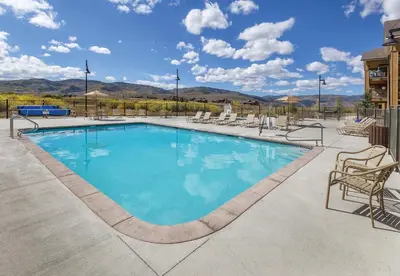 a large swimming pool with chairs around it at WorldMark Granby - Rocky Mountain Preserve in Granby