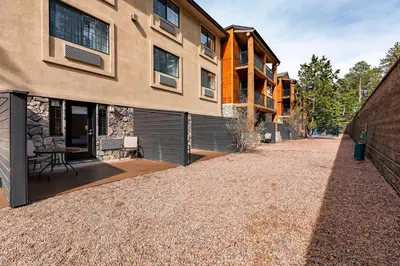 a building with its doors open on a gravel driveway at Comfort Suites Golden West on Evergreen Parkway in Evergreen