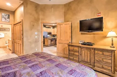 a bedroom with a large bed and a flat screen tv at The Timbers Ski-In, Ski-Out 1 Bedroom Plus Murphy in Keystone