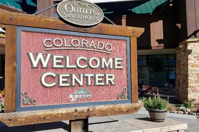 a sign for a welcome center in front of a store at Ski Run - Mountain House Keystone in Keystone