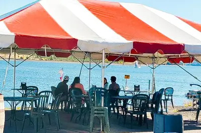 a group of people sitting at a table under an umbrella at Snowdance - Keystone in Dillon