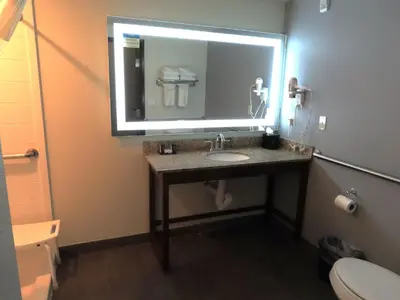 a bathroom with a sink and a large mirror at Sleep Inn & Suites Denver International Airport in Denver