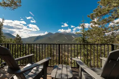 a deck with chairs and a view of mountains at Cedar Upper Condominium 3 Bedroom condo in Estes Park