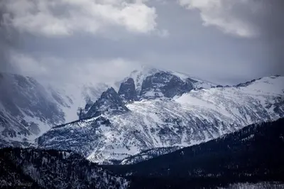 a snow covered mountain with trees in front of it at Sheep Mountain 20B Condo in Estes Park