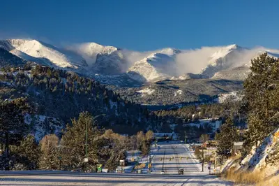 a snow covered mountain range with snow covered mountains at Mount Chiquita 10A Condo in Estes Park