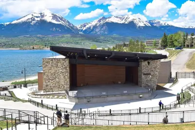 a large building with snow covered mountains in the background at Timber Ridge #410 - Wildernest in Silverthorne