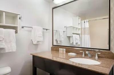 a bathroom with a sink and a mirror at Hampton Inn Boulder/Louisville in Louisville