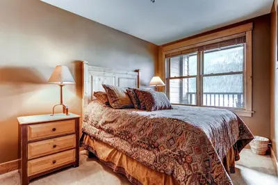 a bedroom with a bed and a window at 1 Bedroom Springs Condo In River Run Village Just 75 Yards From The River Run Gondola in Dillon