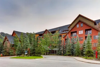 a large red building with trees in front of it at 1 Bedroom Springs Condo In River Run Village Just 75 Yards From The River Run Gondola in Dillon