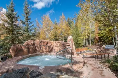 a jacuzzi in the middle of a forest at 1 Bedroom Springs Condo In River Run Village Just 75 Yards From The River Run Gondola in Dillon