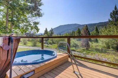 a jacuzzi tub on the deck of a house at Frostfire E41 Condo in Keystone