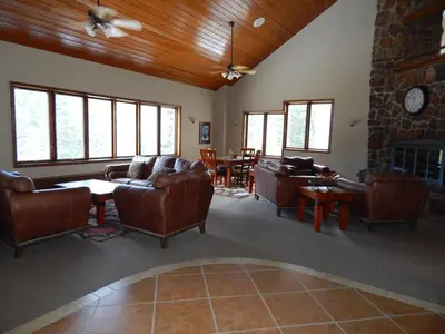 a living room with leather furniture and a stone fireplace at Iron Horse Building C Unit 1023 in Winter Park