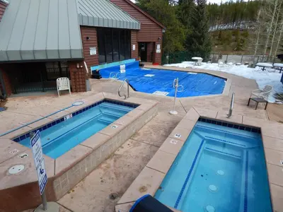 two swimming pools in front of a house at Iron Horse Building D Unit 4104 in Winter Park