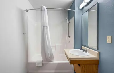 a bathroom with a shower curtain and a sink at Extended Stay America Suites - Denver - Airport in Aurora