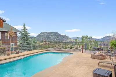 a swimming pool with a view of the mountains at Chiefs Head Peak 21B Condo in Estes Park