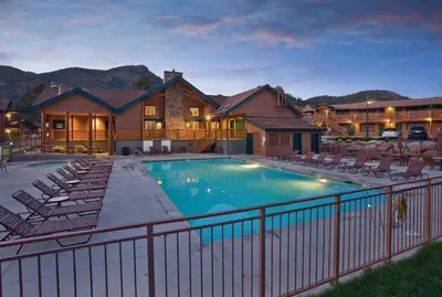 a large swimming pool with chairs and a house at WorldMark Estes Park in Estes Park