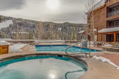 a large swimming pool in front of a building at 1 Bedroom Plus Murphy Mountain Condo In River Run Village With Hot Tub Access And Walking Distance To Ski in Keystone