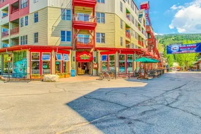 a large building with red trim on a city street at 1 Bedroom Mountain Condo In River Run Village With Beautiful Mountain Views And Walking Distance To Ski in Keystone