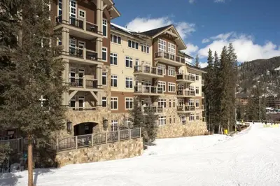 a large building with snow in front of it at Premier 3 Bedroom Ski In, Ski Out Lone Eagle Condo With The Best Access To Skiing In Keystone in Keystone