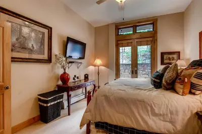 a bedroom with a bed and a tv on the wall at Premier 3 Bedroom Timbers Ski In, Ski Out Vacation Rental At The Timbers With The Best Access To Skiing In Keystone in Keystone