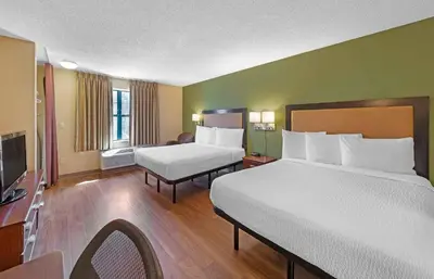 a hotel room with two beds and a television at Extended Stay America Suites - Denver - Aurora North in Aurora