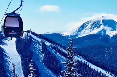 a ski lift going up a snow covered mountain at Treehouse Village 323 in Silverthorne
