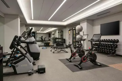 a gym with exercise equipment and a flat screen tv at Home2 Suites By Hilton Denver Downtown Convention Center in Denver