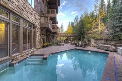 a swimming pool in the backyard of a house at Premier 4 Bedroom Ski In, Ski Out Vacation Rental At The Timbers With The Best Access To Skiing In Keystone in Keystone