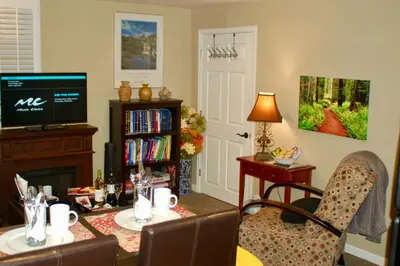 a living room with a television and a table and chairs at Blue Bear Den 3BR 2BA DTC Private Apt Hot Tub in Denver