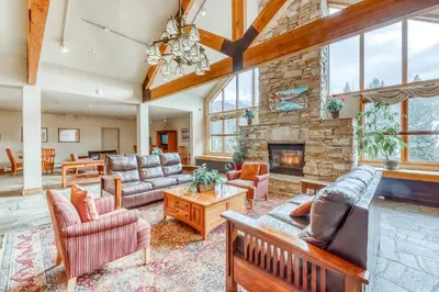 a living room with couches and a stone fireplace at Gateway 5079 in Keystone