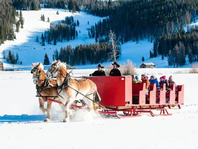 a group of people riding in a horse drawn sleigh in the snow at Three-Bedroom Townhouse in Keystone