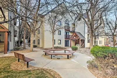 a park with two benches in front of a building at Half-Mi to Light Rail Greenwood Village Studio in Englewood