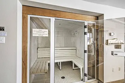 a glass door with a bench inside of a room at Eat, Sleep, Ski! Rustic Mtn Condo WiFi,TV, HotTub in Fraser