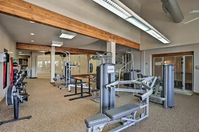 a gym with several treadmills and exercise bikes at Eat, Sleep, Ski! Rustic Mtn Condo WiFi,TV, HotTub in Fraser
