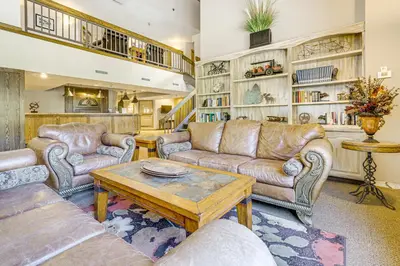 a living room with couches and a coffee table at Ski-InandSki-Out Winter Park Condo with Pool Access! in Winter Park
