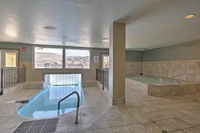 a large bathroom with a hot tub and a swimming pool at 2 Mi to Granby Ranch Condo with Hot Tub Access in Granby