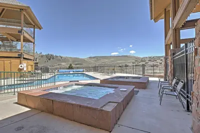 a patio with a pool and a table and chairs at 2 Mi to Granby Ranch Condo with Hot Tub Access in Granby