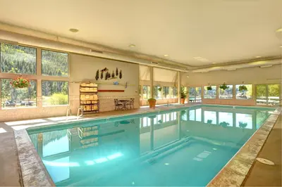 a large swimming pool in a large house at Premier 2BR 2BA in Lakeside Village- Kids Ski Free! condo in Keystone