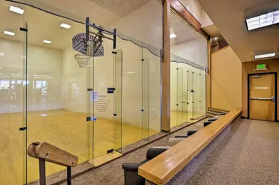 a basketball court with a bench and a basketball hoop at Cozy Fraser Mtn Retreat with Shuttle to Winter Park in Fraser