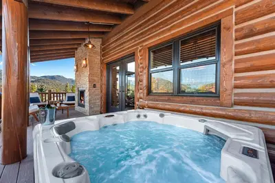a jacuzzi tub in a room with a view at Estes Retreat – Indoor/Outdoor Fireplace, Jacuzzi, Close to Downtown Estes in Estes Park