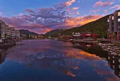 a view of a river in a town at sunset at 2 Bedroom Mountain Condo In Lakeside Village Near Keystone Lake With Complimentary Shuttle Service in Keystone