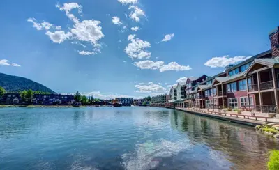 a view of a river with houses and buildings at Lakeside Village 4 Bedroom Condo in Keystone